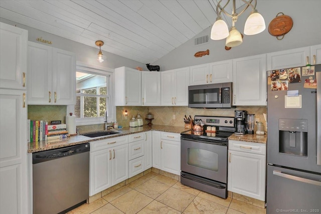 9 Madrina Ln, Madison, CT 06443 - kitchen with appliances with stainless steel finishes, tasteful backsplash, white cabinetry, vaulted ceiling, and light stone counters