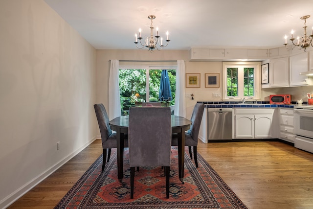 65 Main St Unit 39, Essex, CT 06442 - dining area featuring a chandelier, light wood-style flooring, and healthy amount of natural light
