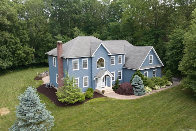 2 Warren Gln, Burlington, CT 06013 - colonial-style house with a chimney, a front lawn, and a wooded view
