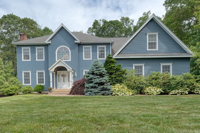 2 Warren Gln, Burlington, CT 06013 - colonial house featuring a chimney, a front yard, and a shingled roof