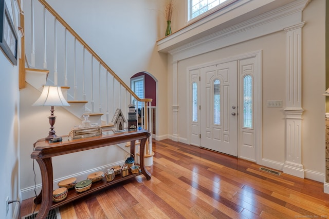 2 Warren Gln, Burlington, CT 06013 - entrance foyer featuring arched walkways, stairway, wood finished floors, and a high ceiling