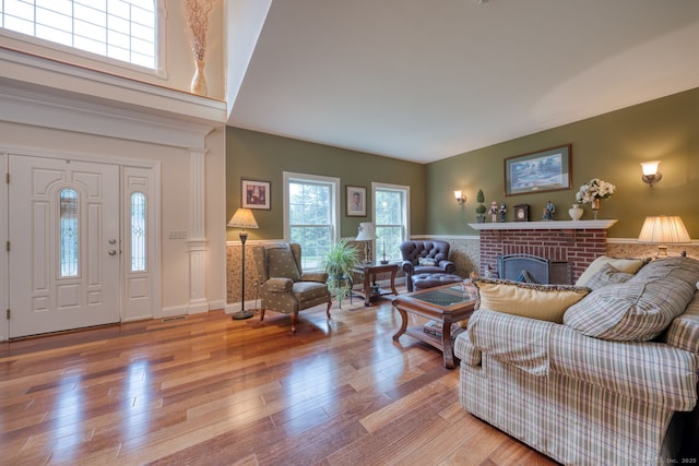 2 Warren Gln, Burlington, CT 06013 - living area featuring a brick fireplace, light wood-style flooring, and a wainscoted wall