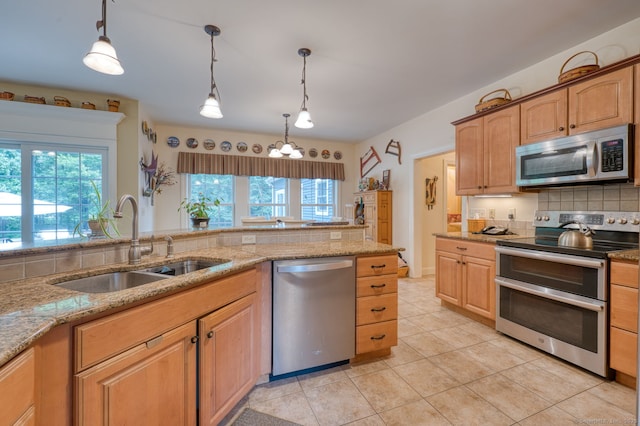 2 Warren Gln, Burlington, CT 06013 - kitchen with stainless steel appliances, tasteful backsplash, healthy amount of natural light, and light stone counters