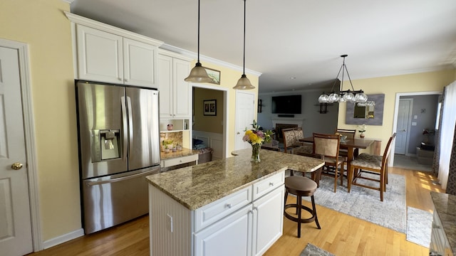 355 Oregon Rd, Cheshire, CT 06410 - kitchen featuring stainless steel fridge with ice dispenser, a fireplace, light wood-style flooring, white cabinetry, and a center island