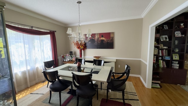 355 Oregon Rd, Cheshire, CT 06410 - dining space featuring wood finished floors, a chandelier, and crown molding
