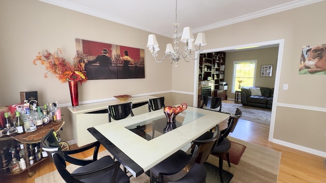 355 Oregon Rd, Cheshire, CT 06410 - dining space featuring ornamental molding, a chandelier, and wood finished floors