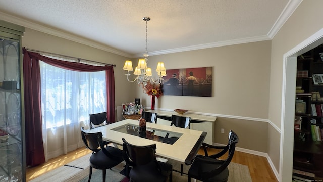 355 Oregon Rd, Cheshire, CT 06410 - dining space featuring wood finished floors, a chandelier, ornamental molding, and a textured ceiling