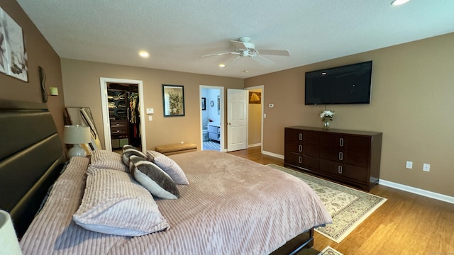 355 Oregon Rd, Cheshire, CT 06410 - bedroom featuring a walk in closet, recessed lighting, wood finished floors, a closet, and ensuite bath