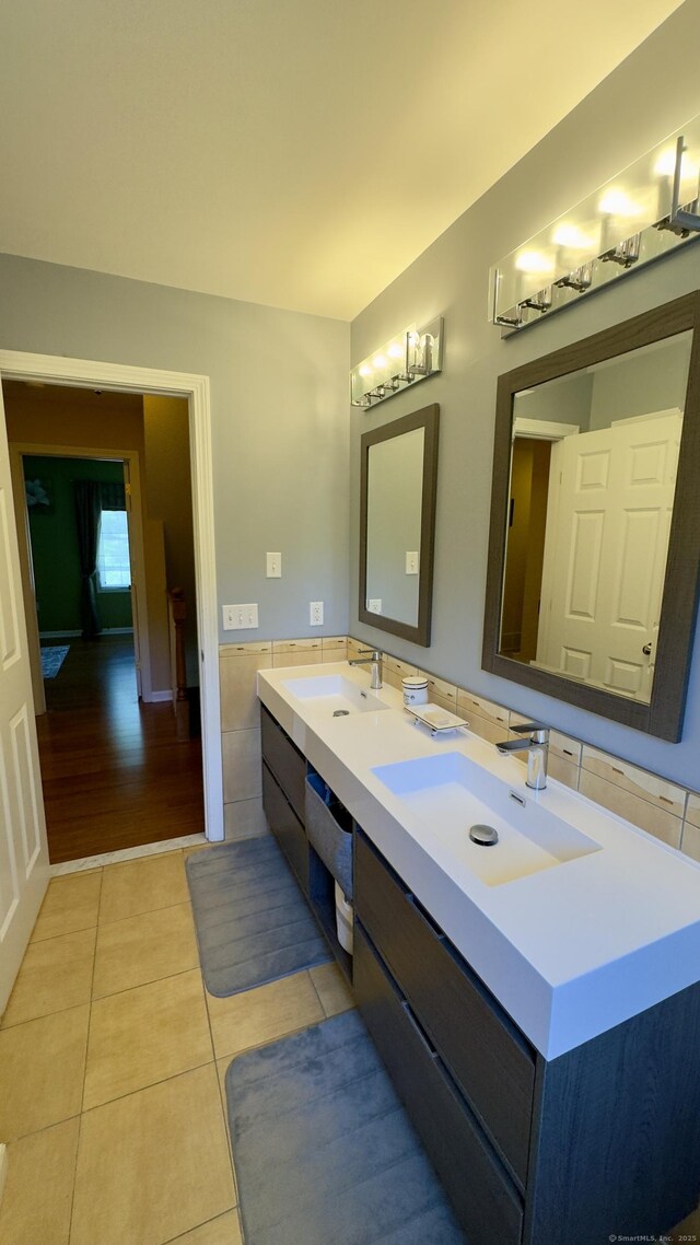 355 Oregon Rd, Cheshire, CT 06410 - full bath featuring tile patterned flooring, double vanity, tile walls, and wainscoting