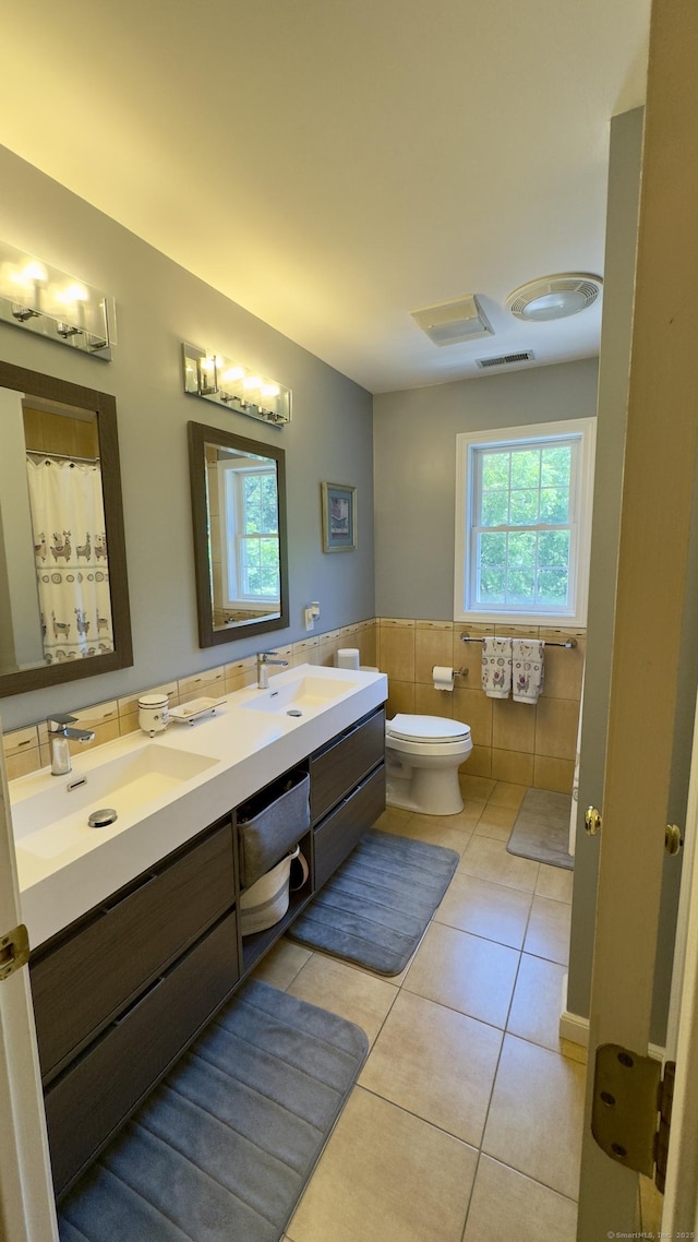 355 Oregon Rd, Cheshire, CT 06410 - full bathroom with tile walls, tile patterned floors, double vanity, a wainscoted wall, and a shower with shower curtain