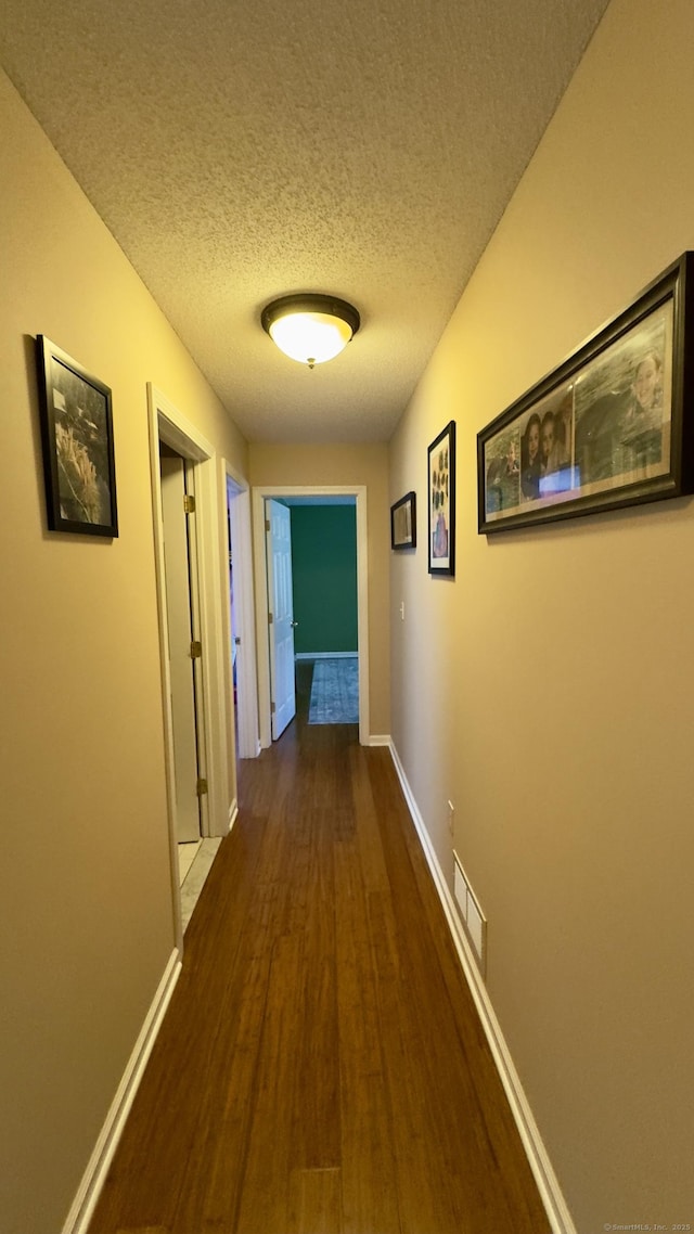 355 Oregon Rd, Cheshire, CT 06410 - hall with dark wood-style flooring and a textured ceiling