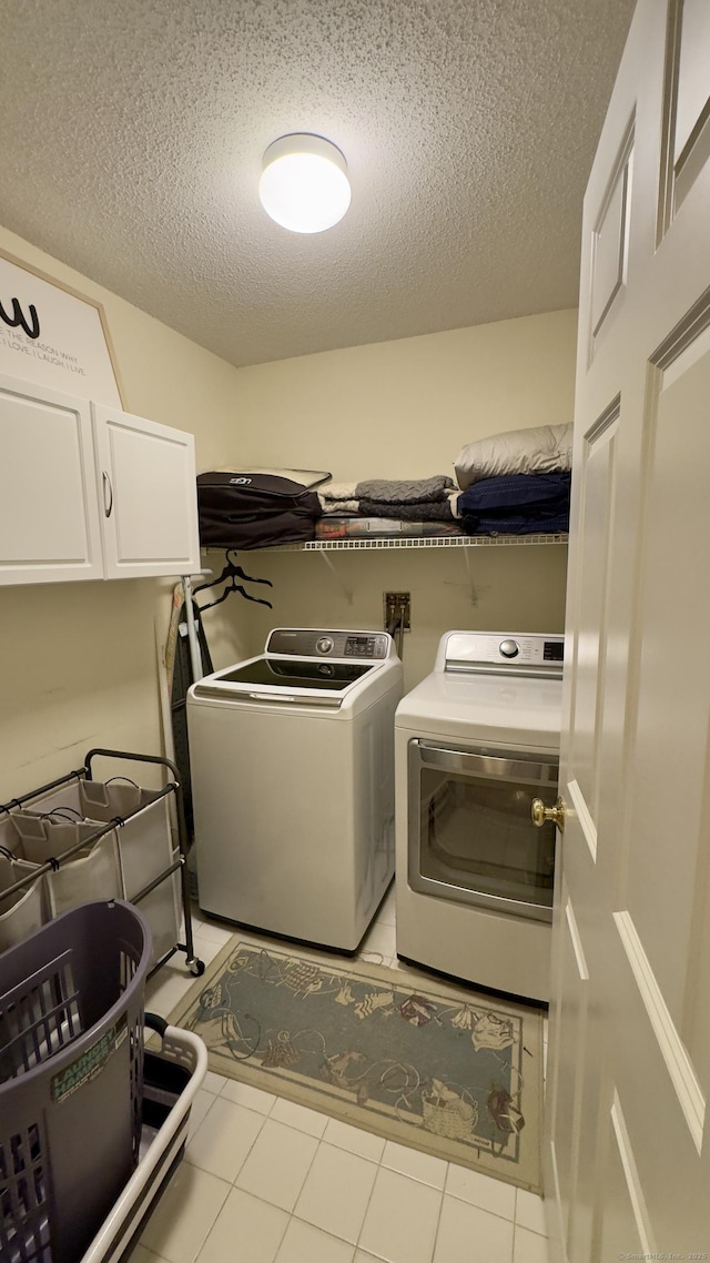 355 Oregon Rd, Cheshire, CT 06410 - washroom featuring cabinet space, separate washer and dryer, and a textured ceiling