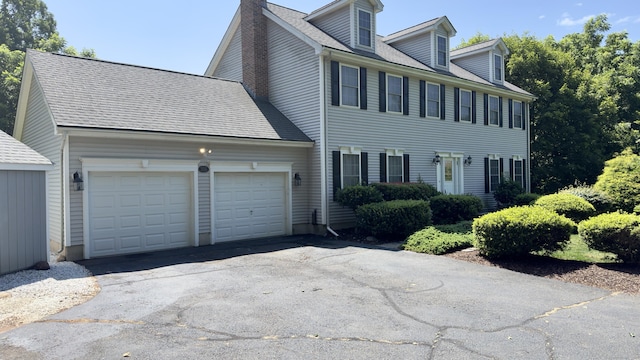 355 Oregon Rd, Cheshire, CT 06410 - view of front of property with an attached garage, asphalt driveway, and a chimney