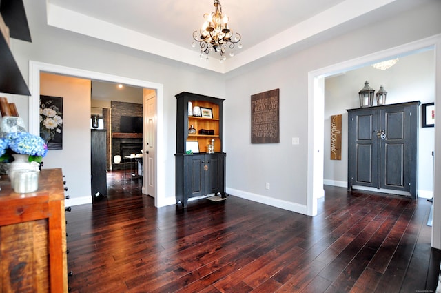 419 Briarwood Dr, Manchester, CT 06040 - entrance foyer with a chandelier, wood finished floors, a fireplace, and a raised ceiling
