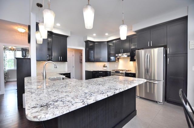 419 Briarwood Dr, Manchester, CT 06040 - kitchen featuring stainless steel appliances, under cabinet range hood, a peninsula, light stone counters, and decorative backsplash