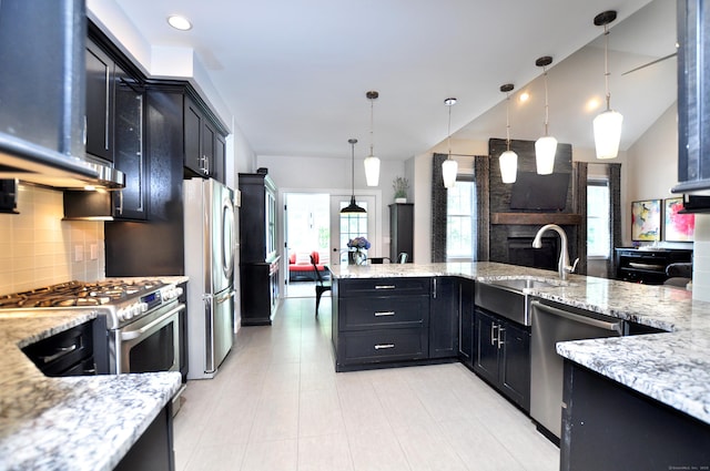 419 Briarwood Dr, Manchester, CT 06040 - kitchen with appliances with stainless steel finishes, dark cabinets, decorative backsplash, light stone countertops, and lofted ceiling