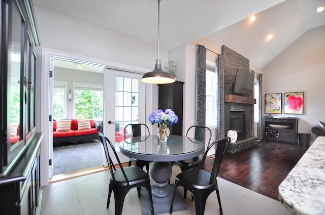 419 Briarwood Dr, Manchester, CT 06040 - dining room with a stone fireplace, lofted ceiling, tile patterned flooring, and recessed lighting