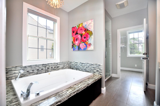 419 Briarwood Dr, Manchester, CT 06040 - full bathroom with a tub with jets, a shower stall, tile patterned flooring, and a chandelier