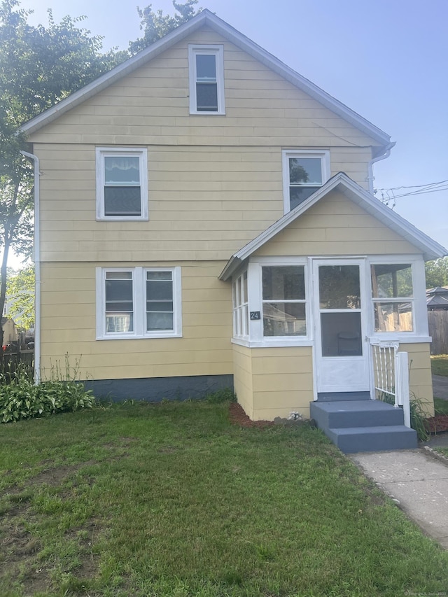 24 Daniel St, East Hartford, CT 06108 - view of front of house featuring a front lawn and a sunroom