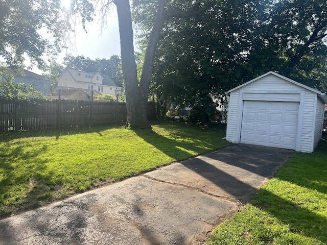 24 Daniel St, East Hartford, CT 06108 - view of yard featuring an outdoor structure, driveway, and a garage