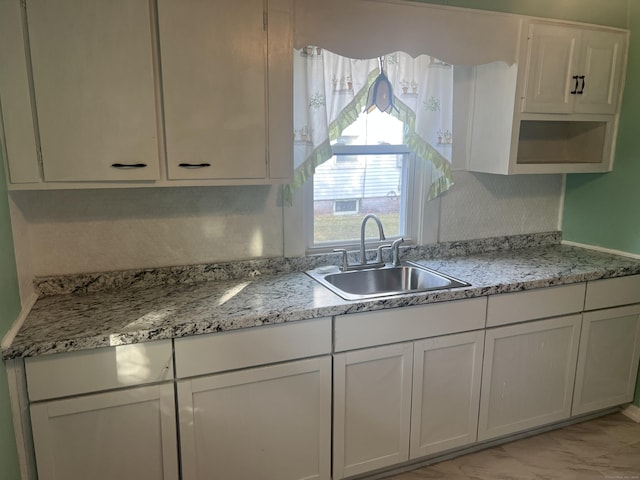 24 Daniel St, East Hartford, CT 06108 - kitchen with white cabinets, light marble finish floors, and light stone counters
