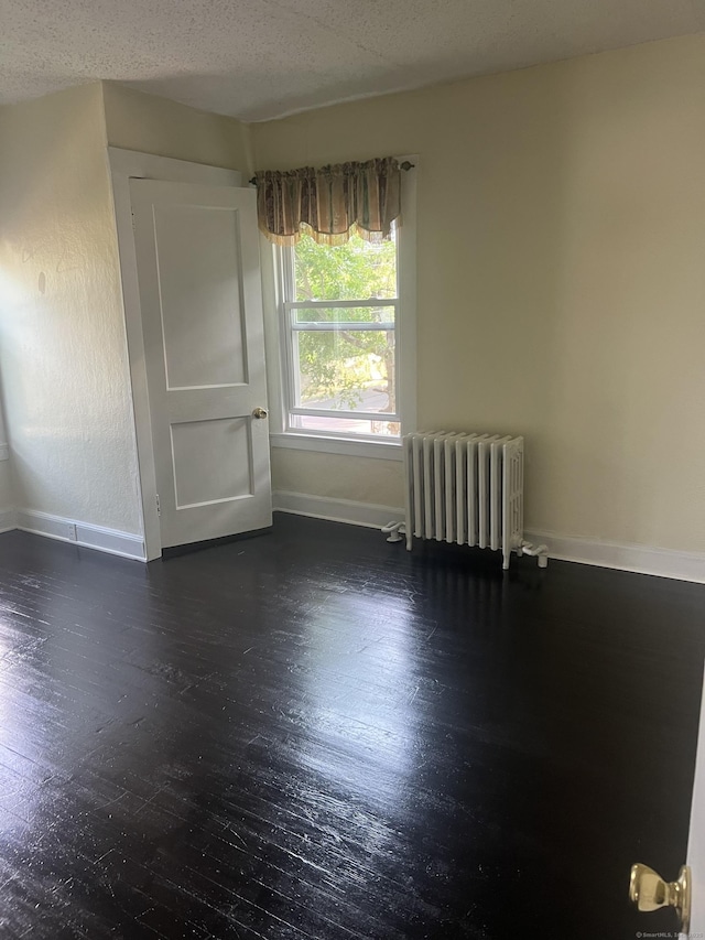 24 Daniel St, East Hartford, CT 06108 - spare room with radiator heating unit and wood finished floors
