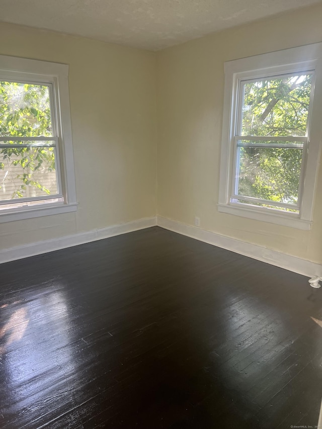 24 Daniel St, East Hartford, CT 06108 - unfurnished room with plenty of natural light and dark wood-style floors