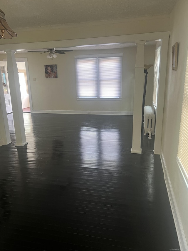 24 Daniel St, East Hartford, CT 06108 - unfurnished room with a ceiling fan, crown molding, dark wood finished floors, and ornate columns