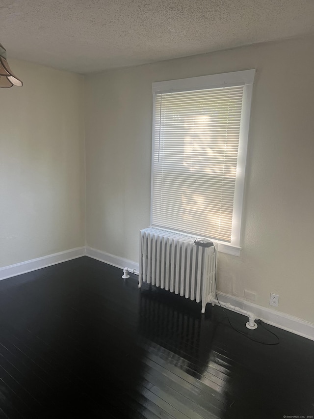 24 Daniel St, East Hartford, CT 06108 - unfurnished room with radiator, hardwood / wood-style floors, and a textured ceiling