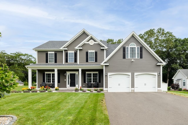 11 Mariani Dr, Southington, CT 06489 - view of front of house featuring driveway, a front yard, a garage, and covered porch