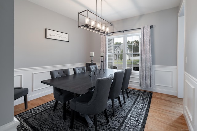 11 Mariani Dr, Southington, CT 06489 - dining area with wainscoting, light wood-style floors, a decorative wall, and a chandelier