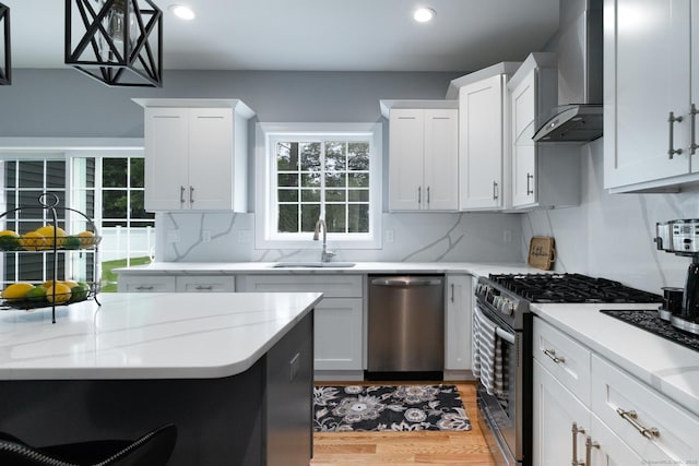 11 Mariani Dr, Southington, CT 06489 - kitchen featuring stainless steel appliances, wall chimney exhaust hood, light wood finished floors, recessed lighting, and decorative backsplash