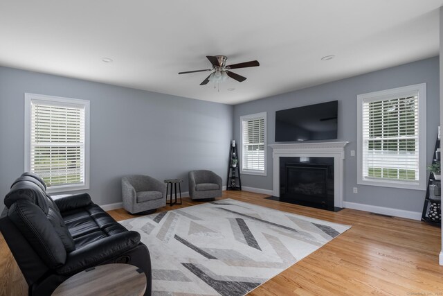 11 Mariani Dr, Southington, CT 06489 - living room with healthy amount of natural light, wood finished floors, a ceiling fan, a fireplace with flush hearth, and recessed lighting