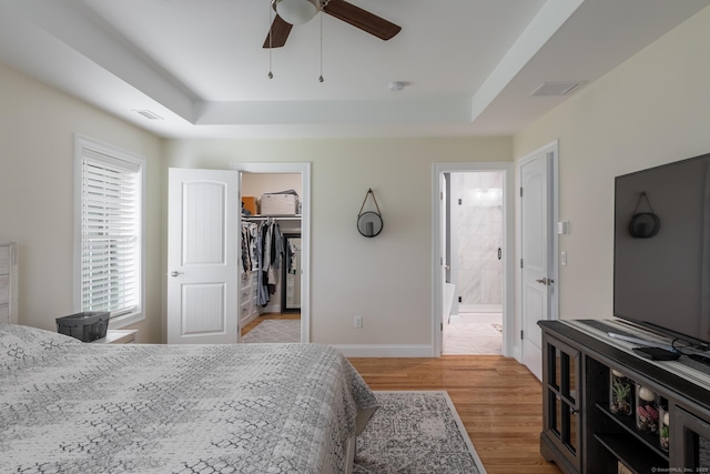 11 Mariani Dr, Southington, CT 06489 - bedroom with a raised ceiling, light wood-style flooring, a walk in closet, ensuite bathroom, and a ceiling fan