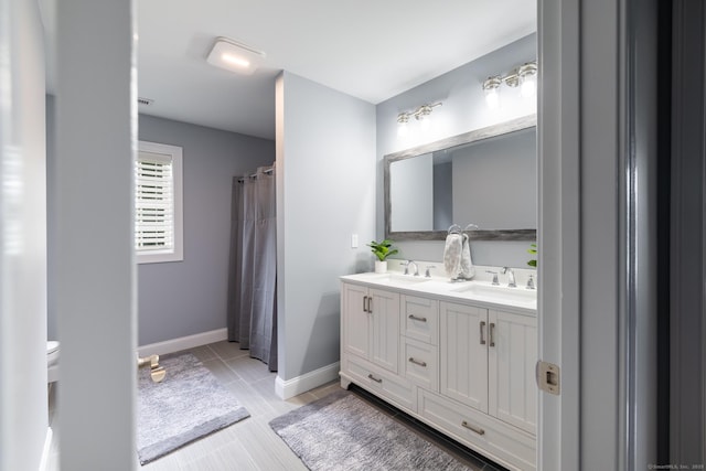 11 Mariani Dr, Southington, CT 06489 - bathroom featuring double vanity and baseboards
