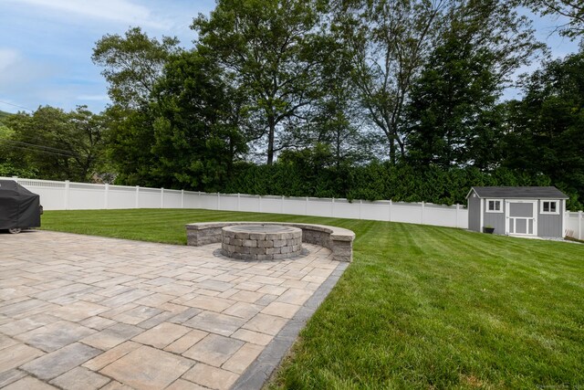 11 Mariani Dr, Southington, CT 06489 - fenced backyard featuring an outdoor fire pit, a patio, a storage shed, and grilling area