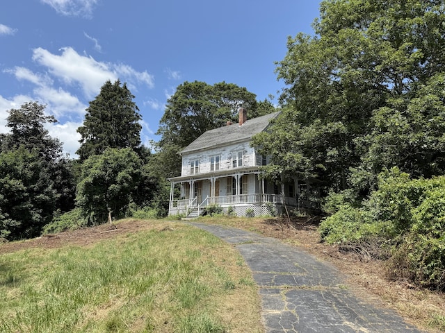 4 Bindloss Rd, Groton, CT 06355 - view of front of home with covered porch, a chimney, and asphalt driveway