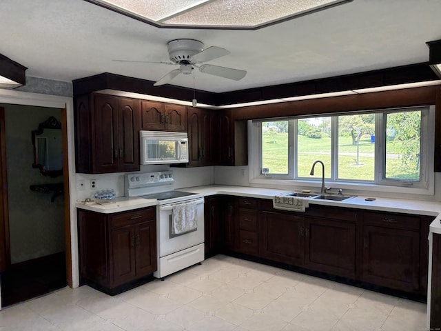 15 S Meadow Dr, Danbury, CT 06811 - kitchen with white appliances, light countertops, dark brown cabinetry, and a ceiling fan