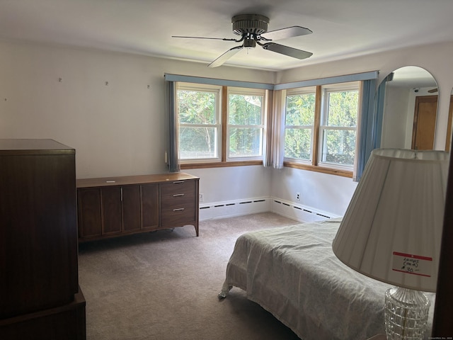 15 S Meadow Dr, Danbury, CT 06811 - carpeted bedroom with arched walkways, multiple windows, ceiling fan, and a baseboard heating unit