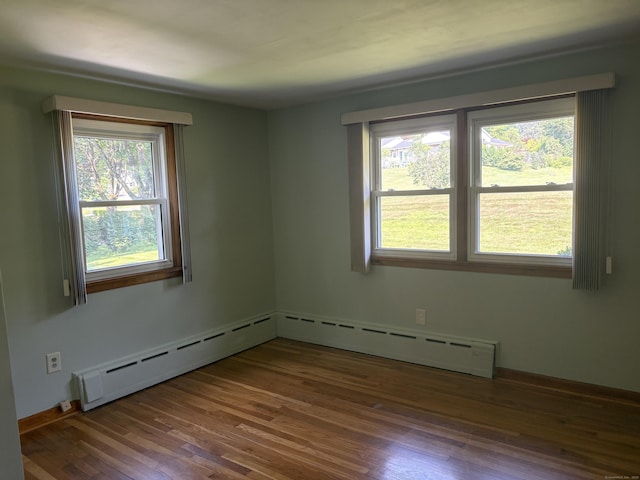 15 S Meadow Dr, Danbury, CT 06811 - empty room with wood finished floors and a baseboard heating unit