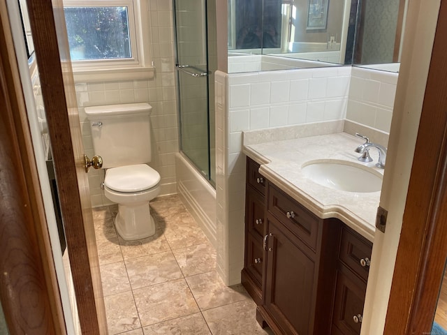 15 S Meadow Dr, Danbury, CT 06811 - bathroom featuring vanity, shower / bath combination with glass door, tile walls, and tile patterned flooring