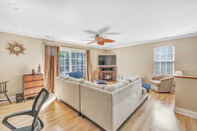97 Ferry Ct Unit 97, Stratford, CT 06615 - living room featuring a ceiling fan, light wood-type flooring, ornamental molding, and a glass covered fireplace