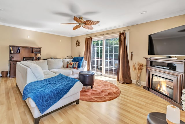 97 Ferry Ct Unit 97, Stratford, CT 06615 - living area featuring light wood-style floors, a ceiling fan, ornamental molding, and a glass covered fireplace