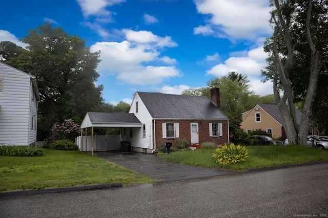 36 Packard St, Manchester, CT 06040 - cape cod-style house with a chimney, brick siding, driveway, an attached carport, and a front yard