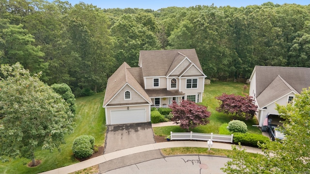 2 Spinnaker Dr Unit 2, East Lyme, CT 06357 - view of front of property with a garage, driveway, a front lawn, and a view of trees