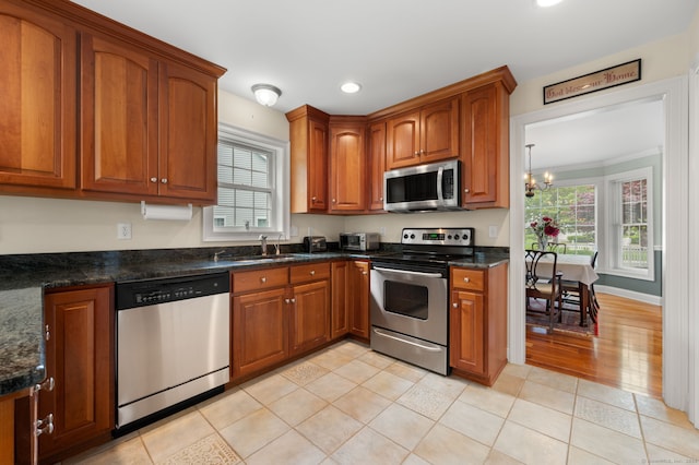 2 Spinnaker Dr Unit 2, East Lyme, CT 06357 - kitchen featuring appliances with stainless steel finishes, brown cabinets, recessed lighting, healthy amount of natural light, and a chandelier