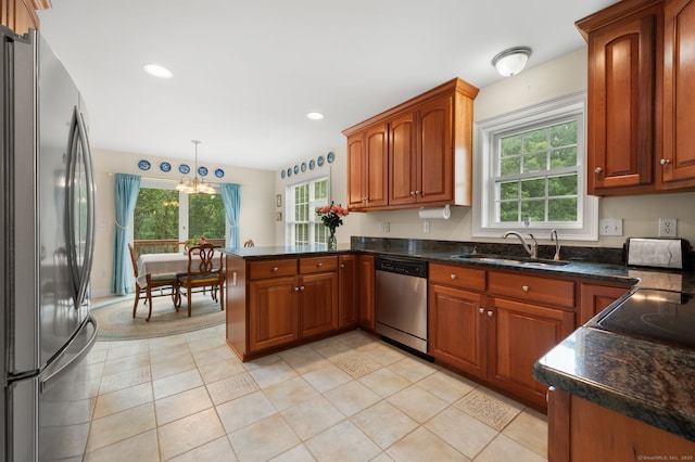 2 Spinnaker Dr Unit 2, East Lyme, CT 06357 - kitchen featuring stainless steel appliances, a chandelier, a peninsula, hanging light fixtures, and brown cabinetry