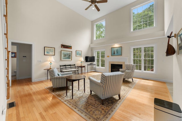 2 Spinnaker Dr Unit 2, East Lyme, CT 06357 - living room with high vaulted ceiling, ceiling fan, wood-type flooring, healthy amount of natural light, and a fireplace