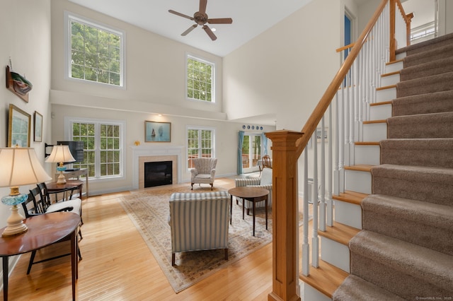 2 Spinnaker Dr Unit 2, East Lyme, CT 06357 - living room featuring a high ceiling, hardwood / wood-style floors, stairway, and a fireplace with flush hearth