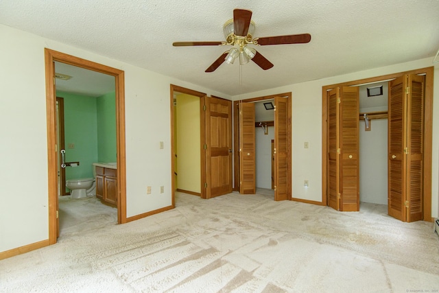 132 Wade Rd, Pomfret, CT 06259 - unfurnished bedroom with two closets, ensuite bathroom, a textured ceiling, carpet, and a ceiling fan